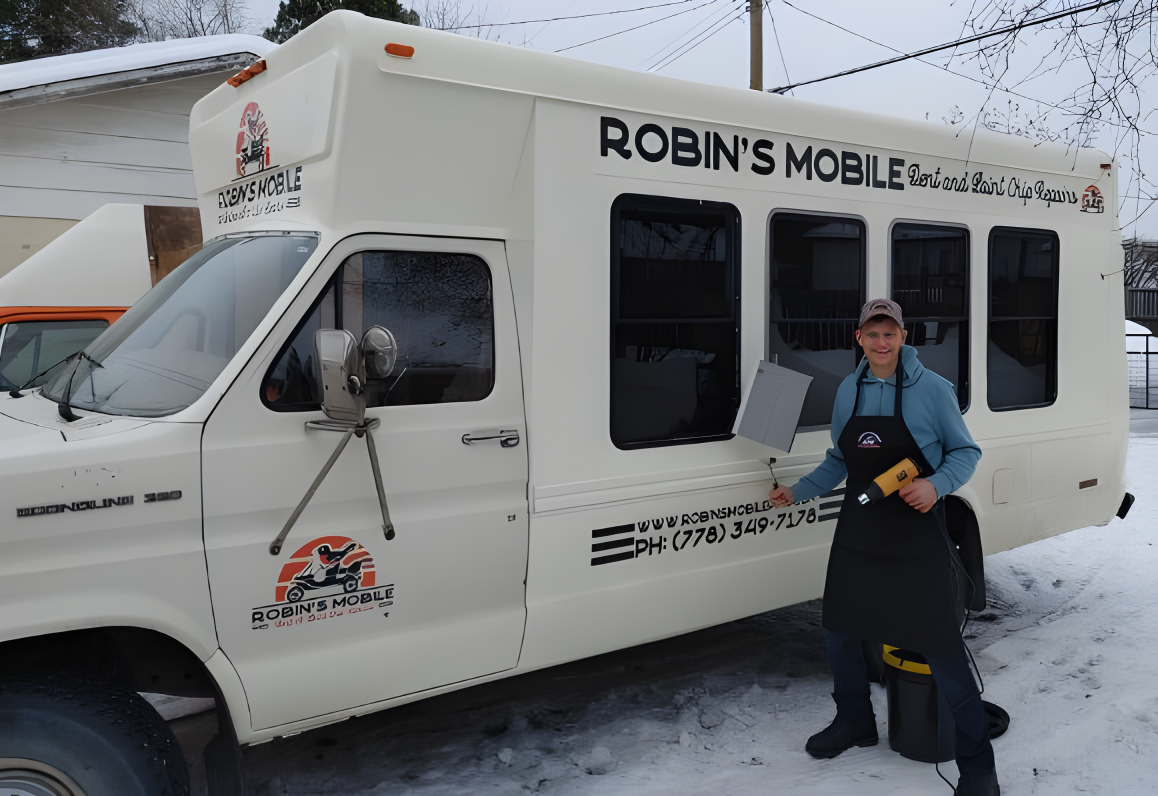 Shane beside the Robin's Mobile van, ready for on-site dent repair in Prince George